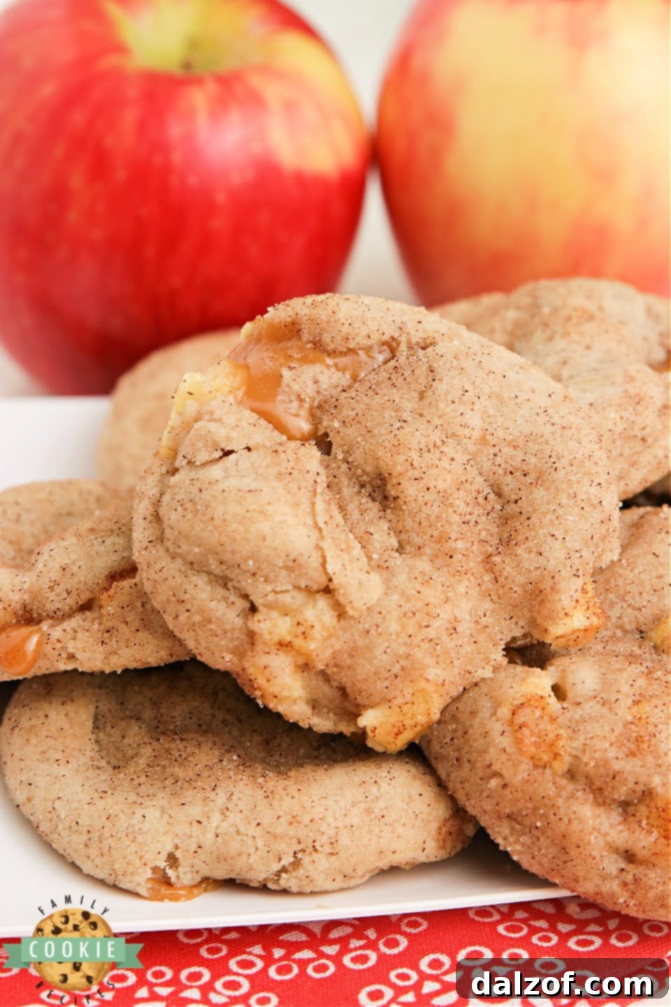 A perfectly baked Caramel Apple Snickerdoodle cookie, showing its soft interior and the melted caramel peeking out, a true fall delight.