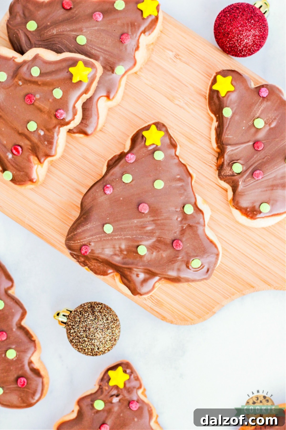 Christmas Tree Twix Cookies are made with a simple sugar cookie topped with caramel, chocolate, and festive sprinkles. Delicious holiday cookies that taste just like your favorite candy bar!