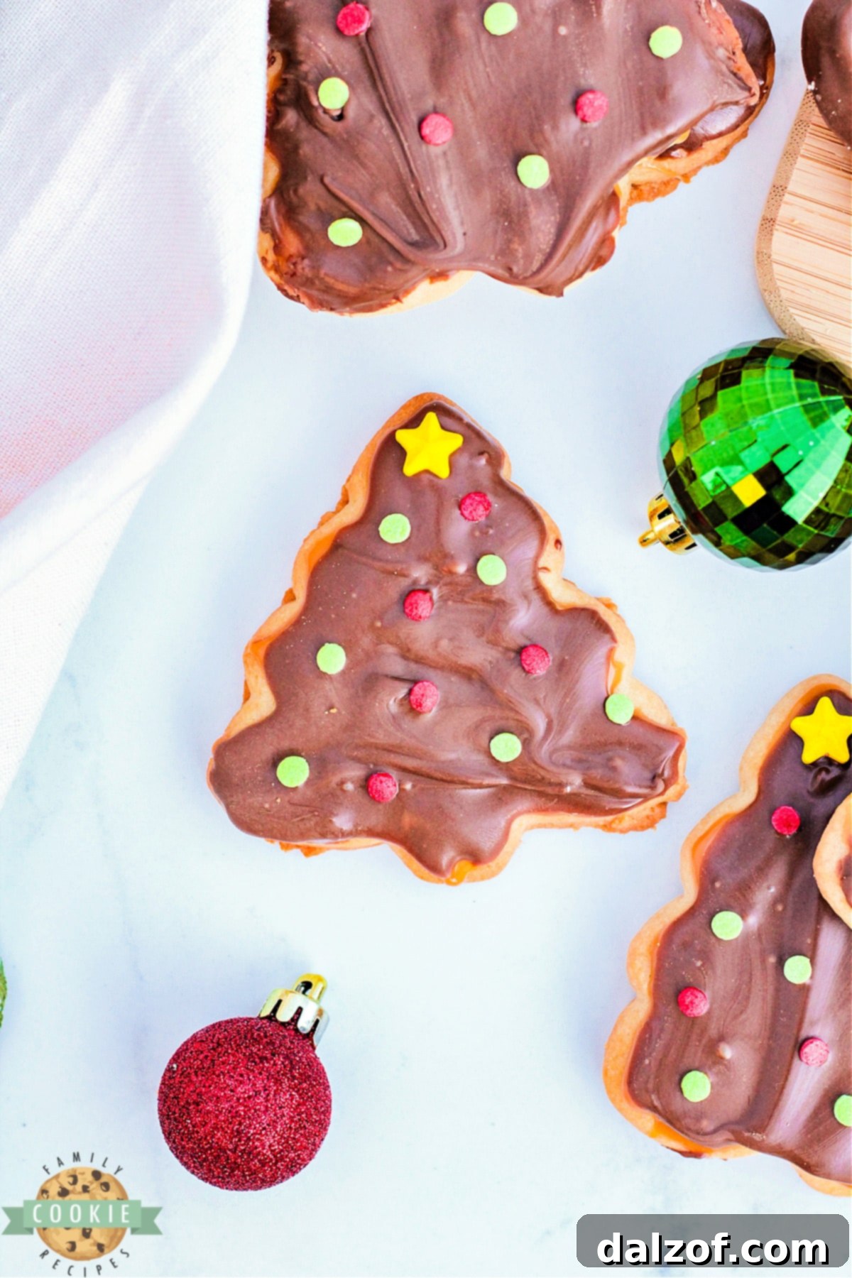 Homemade twix cookies in the shape of Christmas trees.