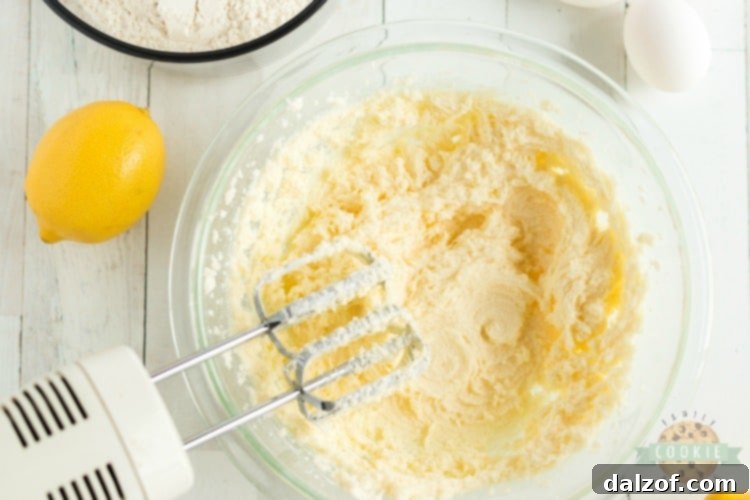 Ingredients for lemon jello sugar cookies including butter, sugar, eggs, flour, and a box of Jello
