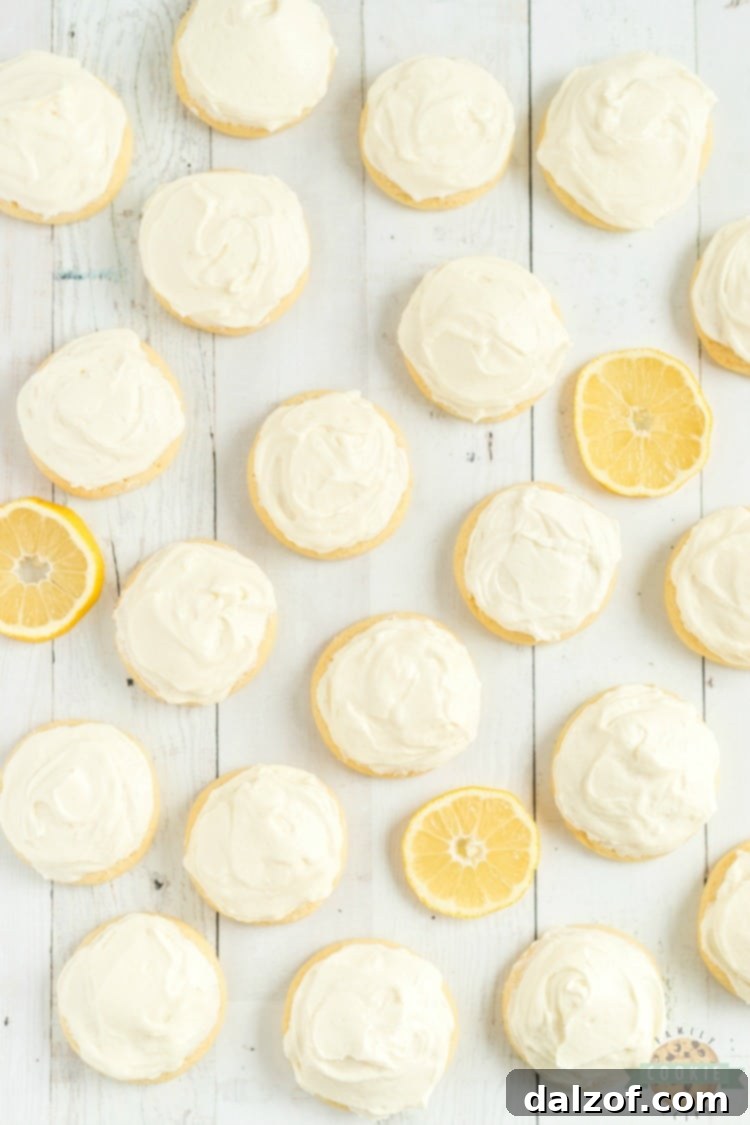 Pile of frosted lemon jello sugar cookies on a cooling rack