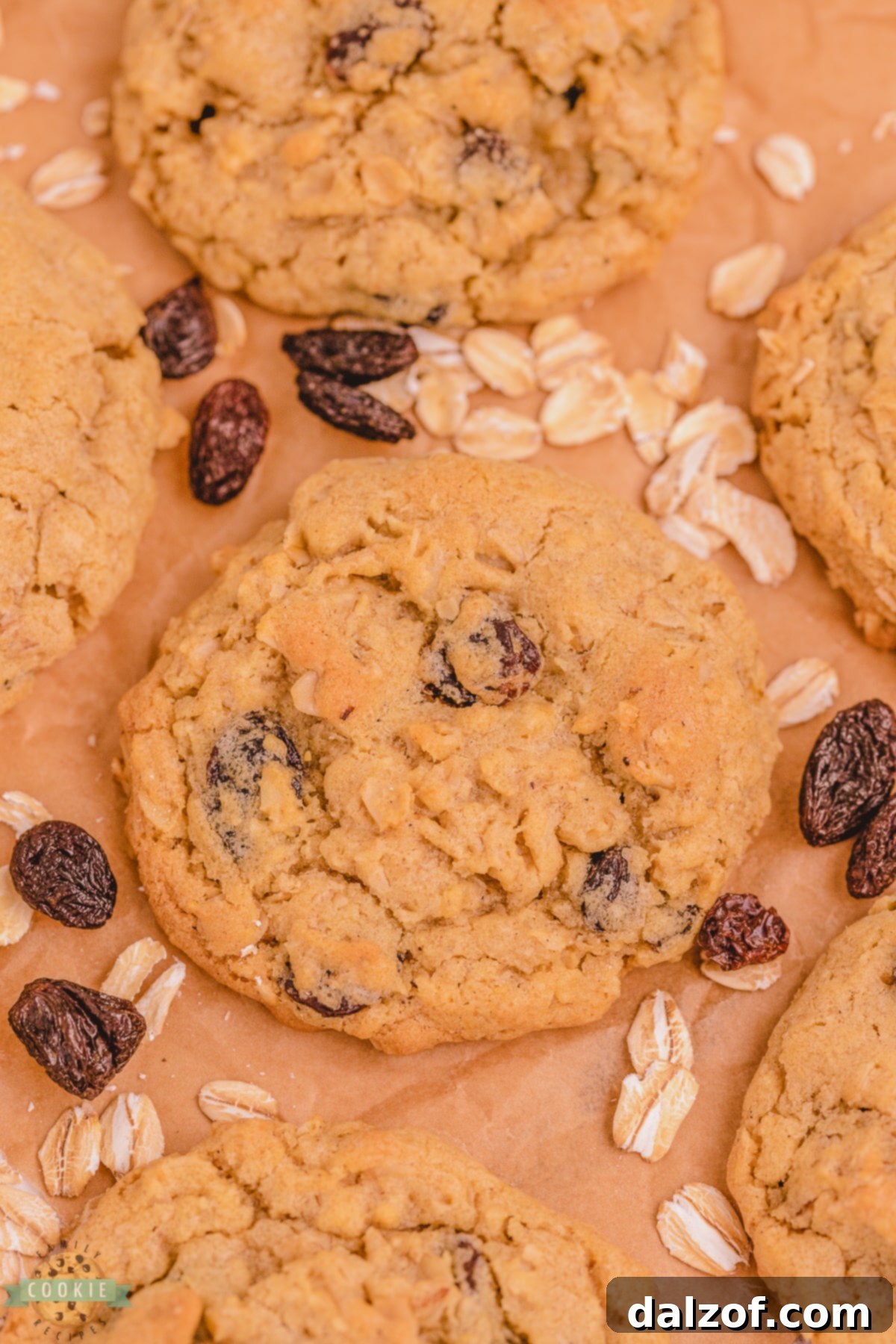 Best ever oatmeal raisin cookies with cinnamon and allspice, stacked high on a wooden surface.
