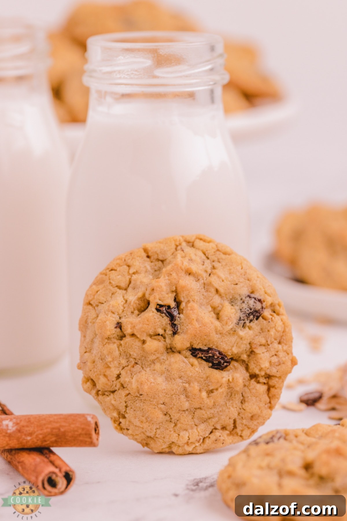 Freshly baked oatmeal raisin cookies paired with a glass of milk.