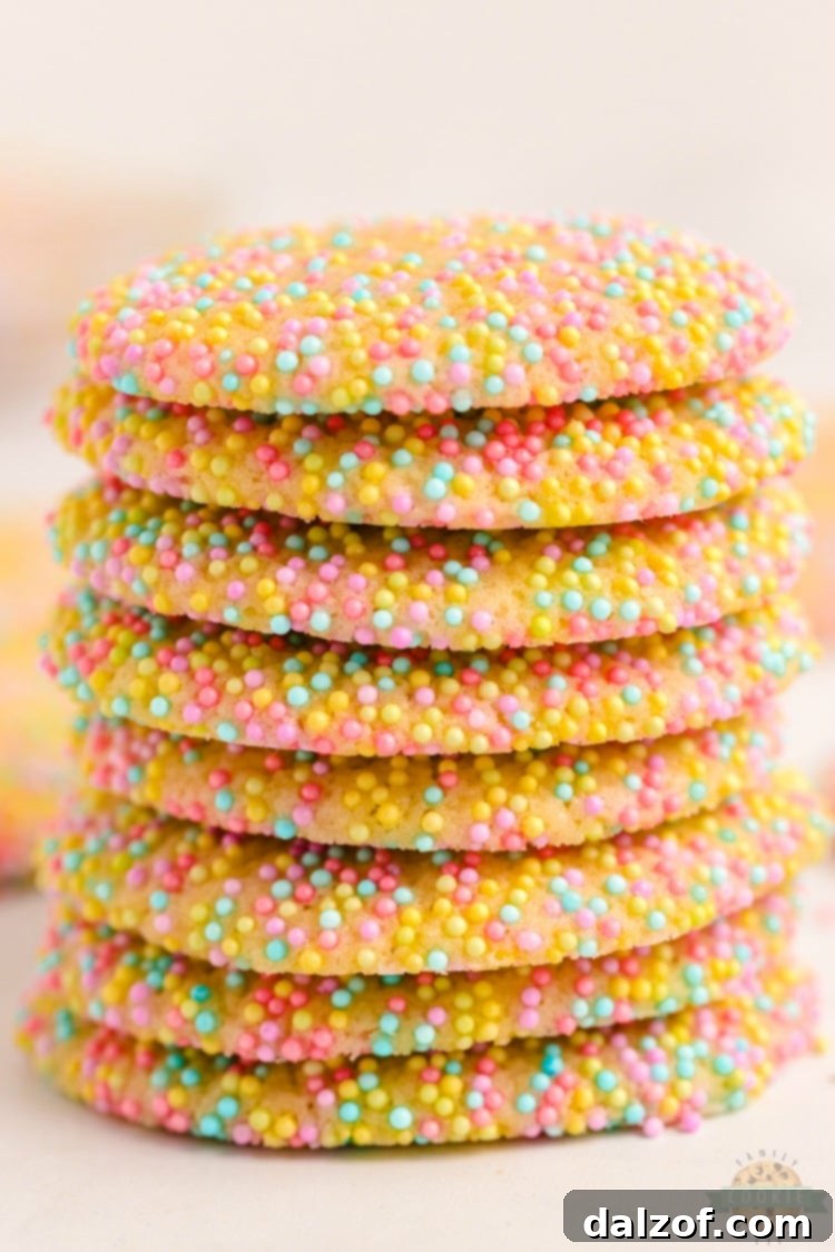 Baked Easter sprinkle cookies with slightly melted pastel sprinkles on a baking sheet.