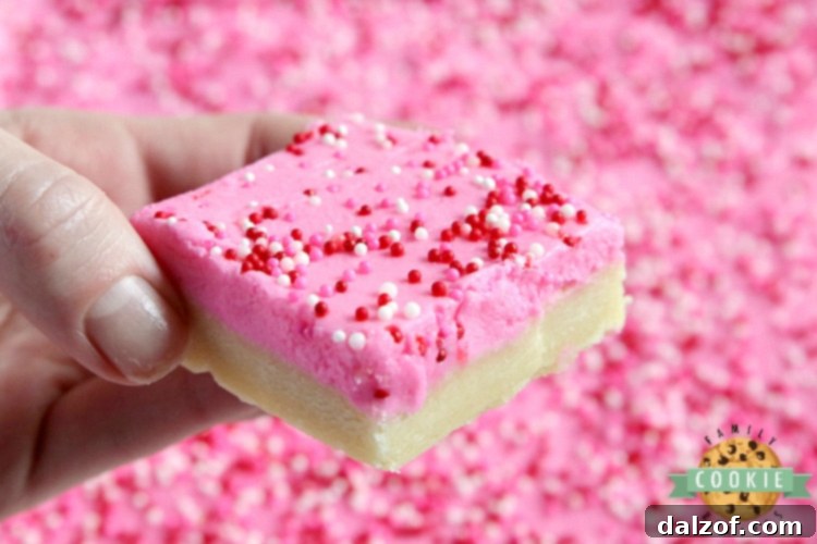 A close-up view of thick and soft sugar cookie bars with a light golden brown edge, showcasing their inviting texture.
