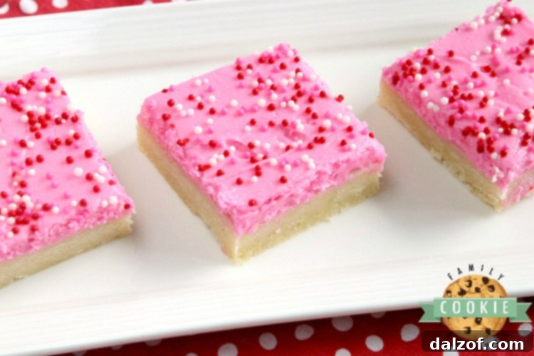 A tray of freshly baked sugar cookie bars, showcasing their soft texture and golden edges before frosting.