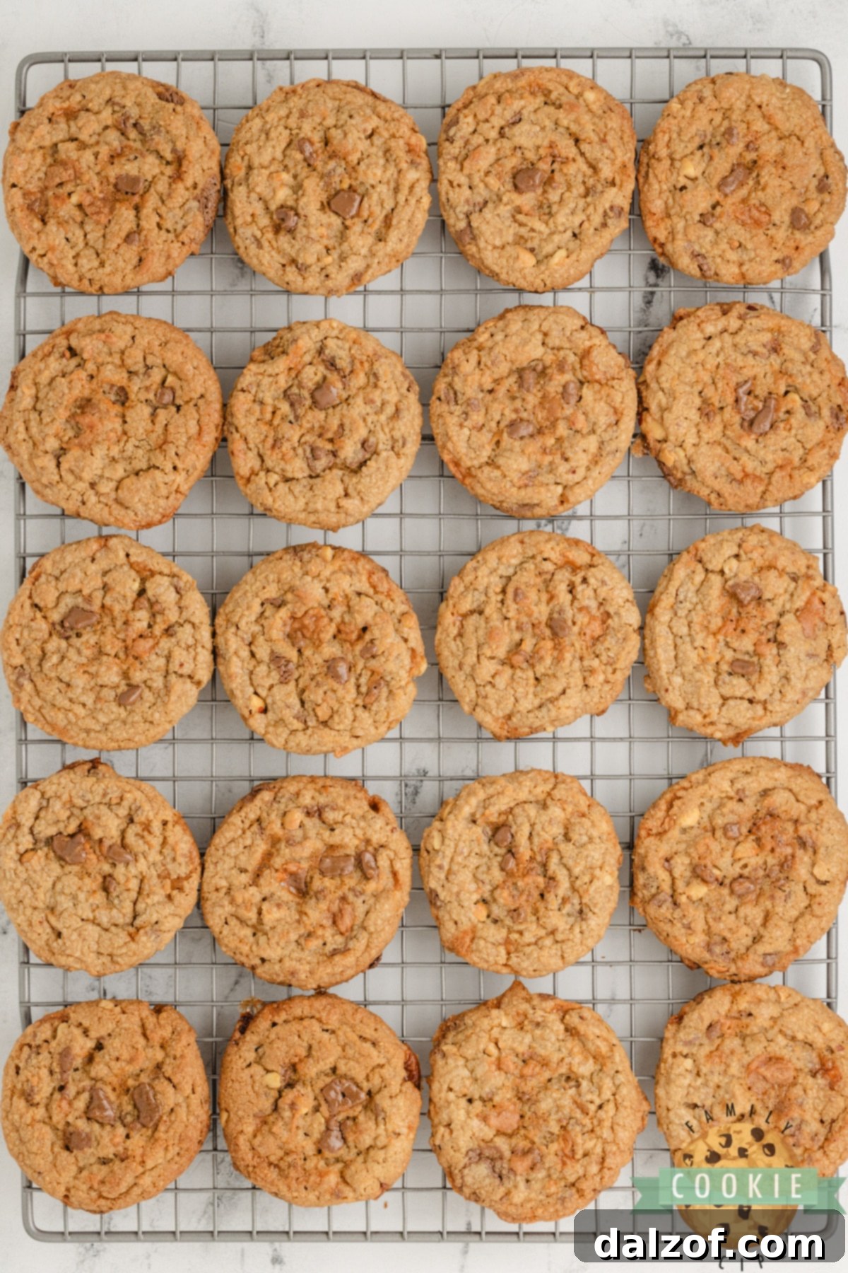 Freshly baked Butterfinger Peanut Butter Cookies cooling on a wire rack, ready to be enjoyed.