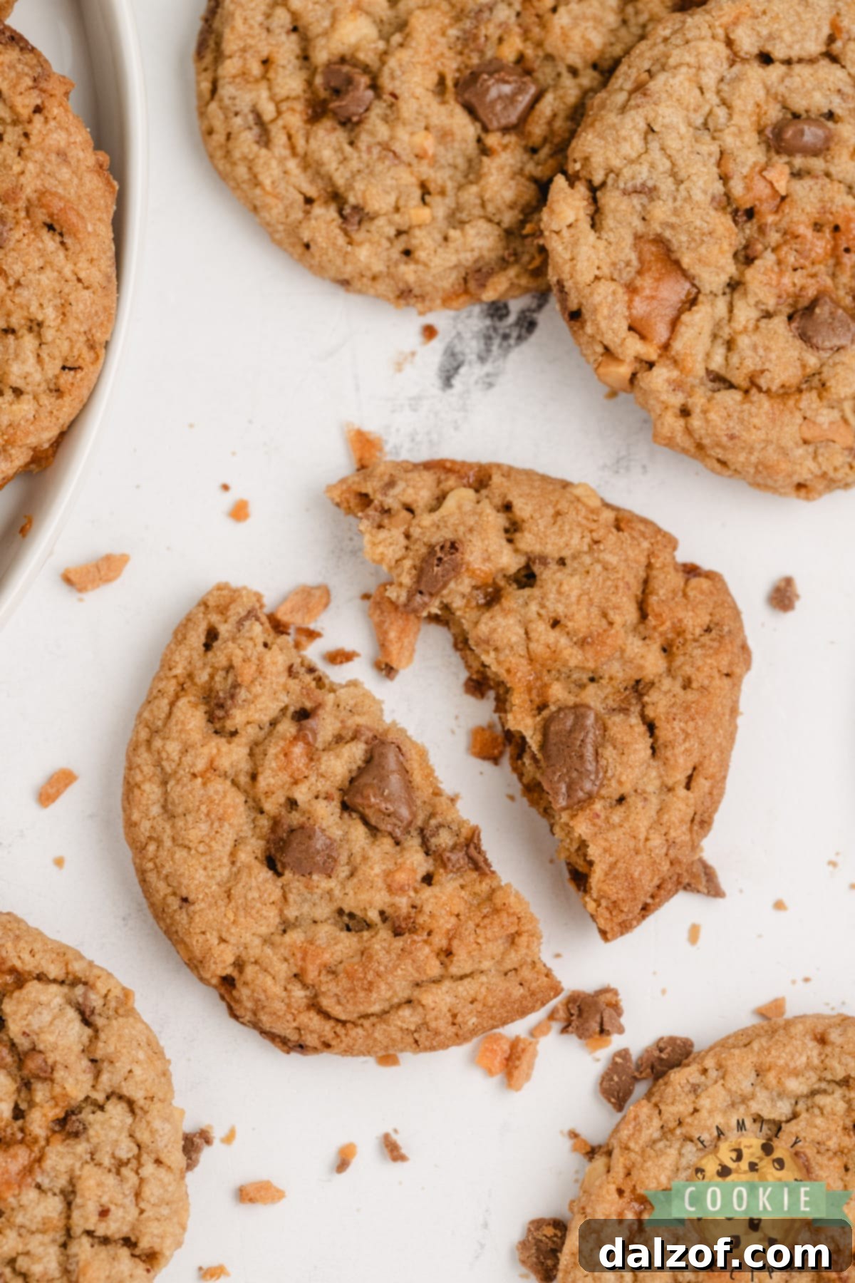 Close-up of a single Butterfinger Peanut Butter Cookie, highlighting the texture and candy bar chunks.