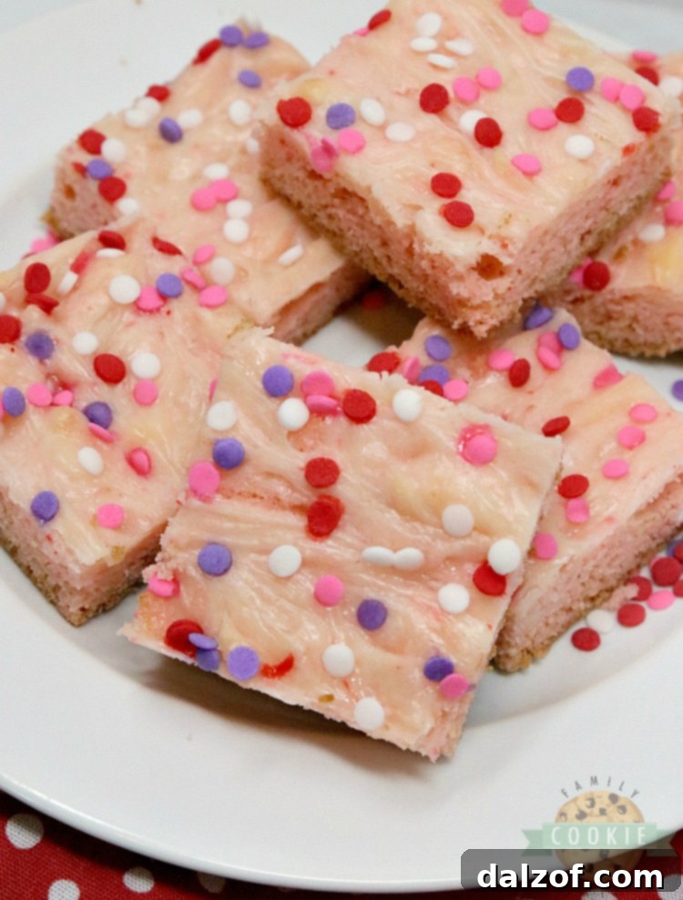 Strawberry Cheesecake Cookie Bars are made with a strawberry cake mix with a simple sweet cream cheese filling swirled in. Only 6 ingredients for these simple cookie bars that are soft, sweet and taste like strawberry cheesecake in cookie form!
