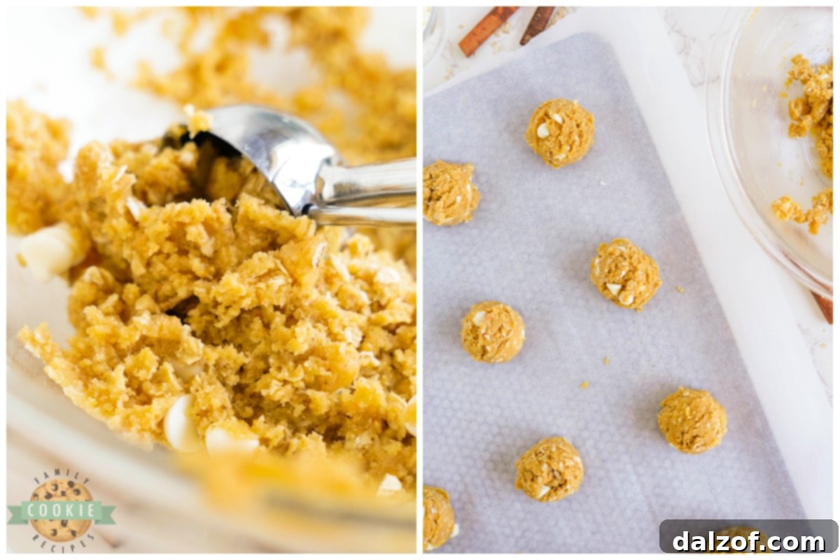 Scooping cookie dough onto a parchment-lined baking sheet using a cookie scoop.