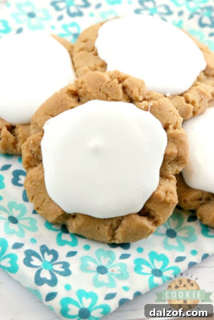 Fluffernutter Cookies take a traditional peanut butter cookie recipe to the next level by adding marshmallow fluff to the top! The peanut butter and marshmallow combination is absolutely amazing in this cookie recipe!