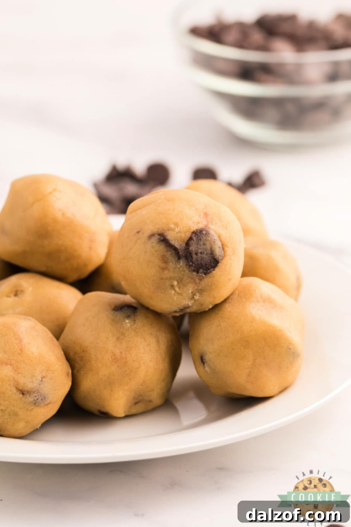 Chocolate Chip Cookie Dough Bites are the ultimate way to enjoy eating raw cookie dough, without worrying about the uncooked egg and flour. Edible chocolate chip cookie dough that is safe to eat, and perfectly portioned for a quick treat!