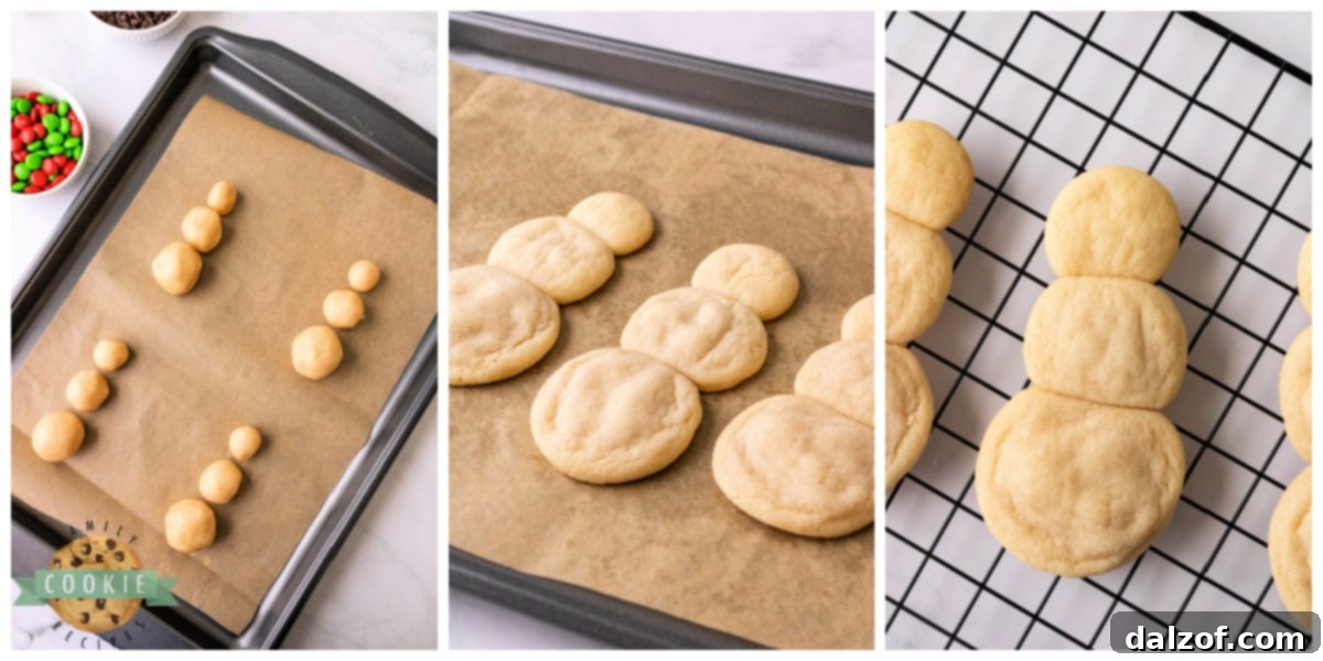 Various sizes of cookie dough balls arranged on a baking sheet to form snowman shapes before baking.