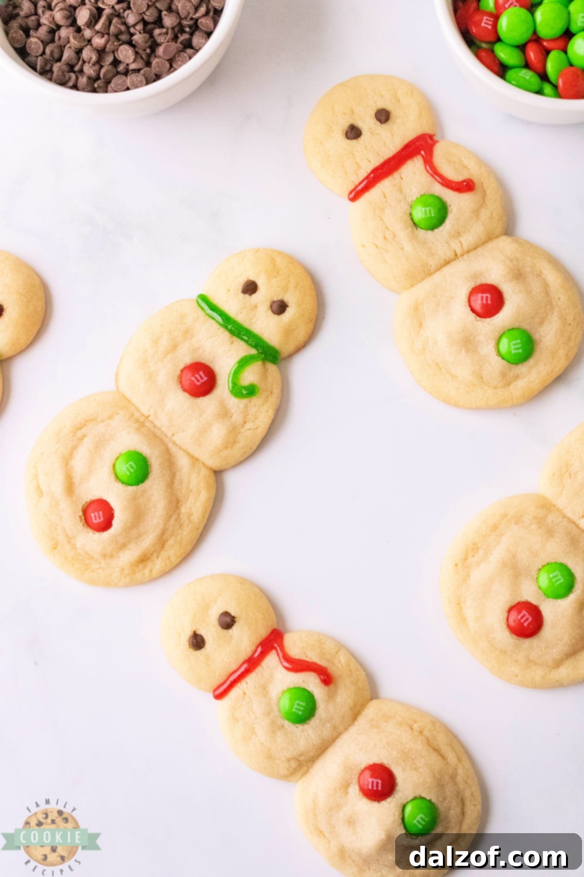 A batch of delightful Snowman Sugar Cookies, soft, chewy, and rich in vanilla flavor, ready for holiday enjoyment, no chilling, cookie cutters, or frosting required.