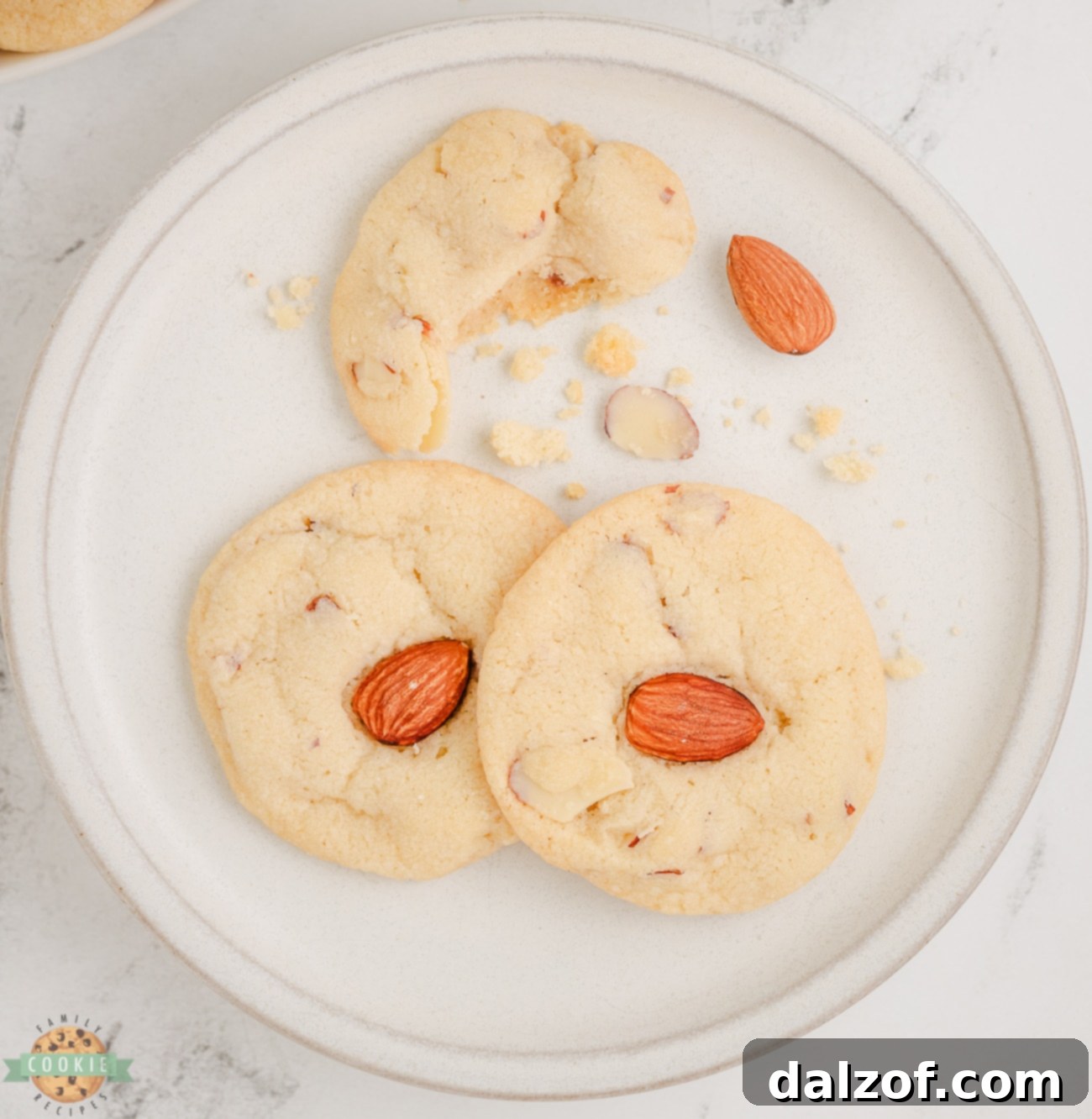 Delicious almond cookies adorned with sliced and whole almonds, showcasing their inviting texture.
