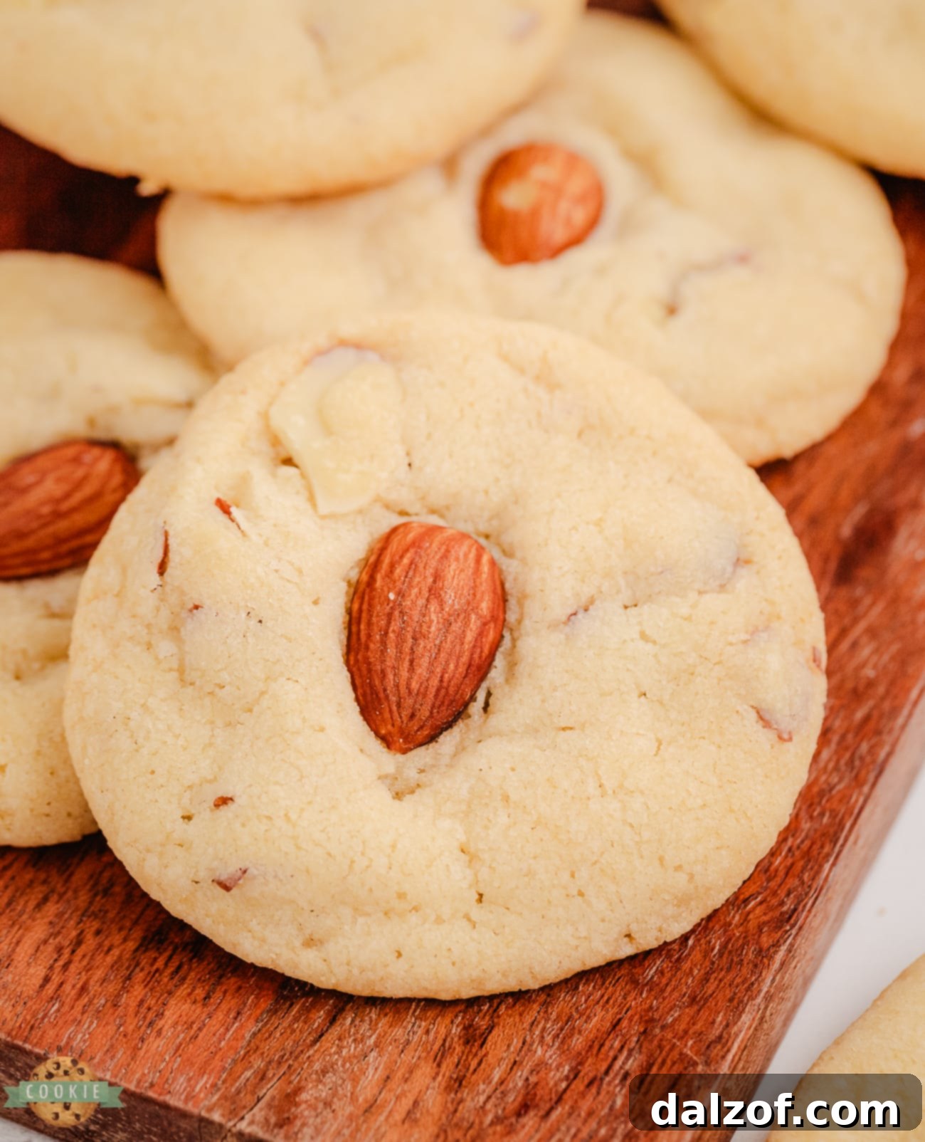 Buttery drop cookies topped with crunchy almonds, showcased on a cooling rack.