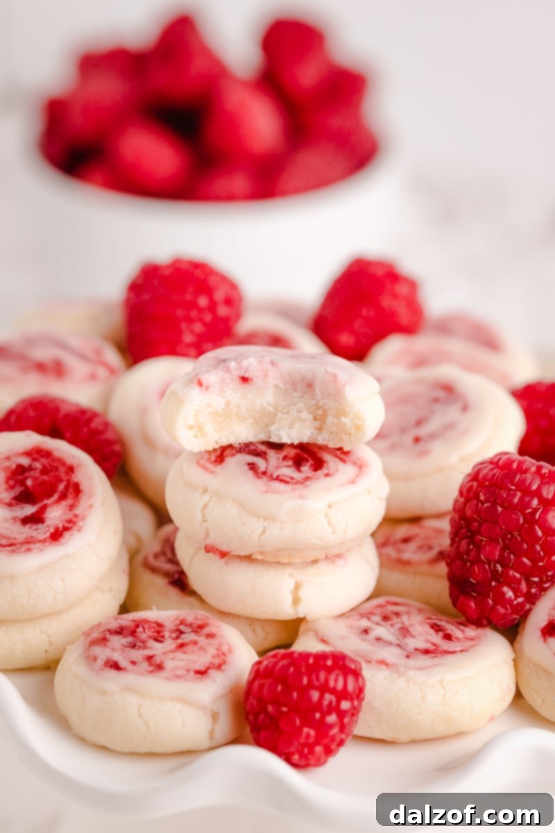 Stack of Raspberry Meltaway Cookies on a white plate