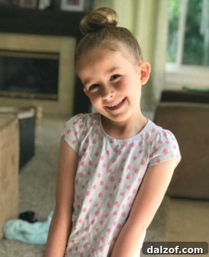 A young girl smiling with Raspberry Meltaway Cookies