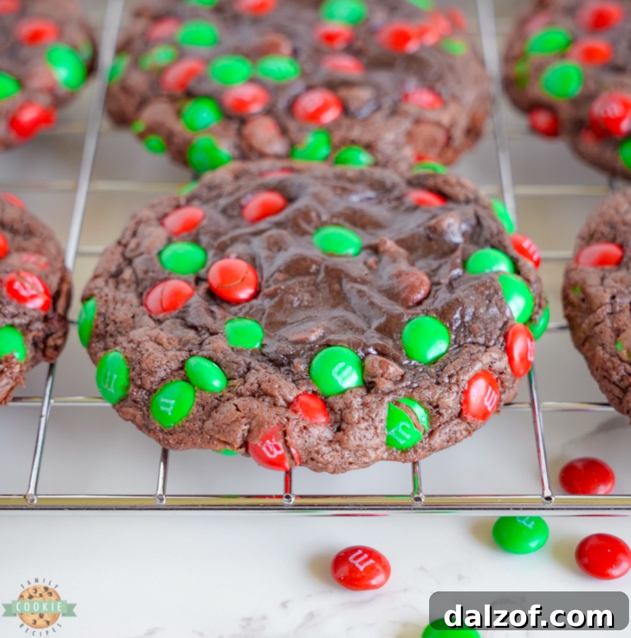 brownie cookies topped with Christmas M&M's on a cooling rack