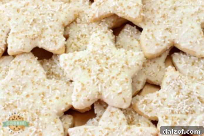 Holiday Star Cookies are bright, buttery & sparkly. They're perfect for the holidays! Candy coated & sprinkled to holiday perfection, everyone loves these melt-in-your mouth vanilla shortbread cookies.