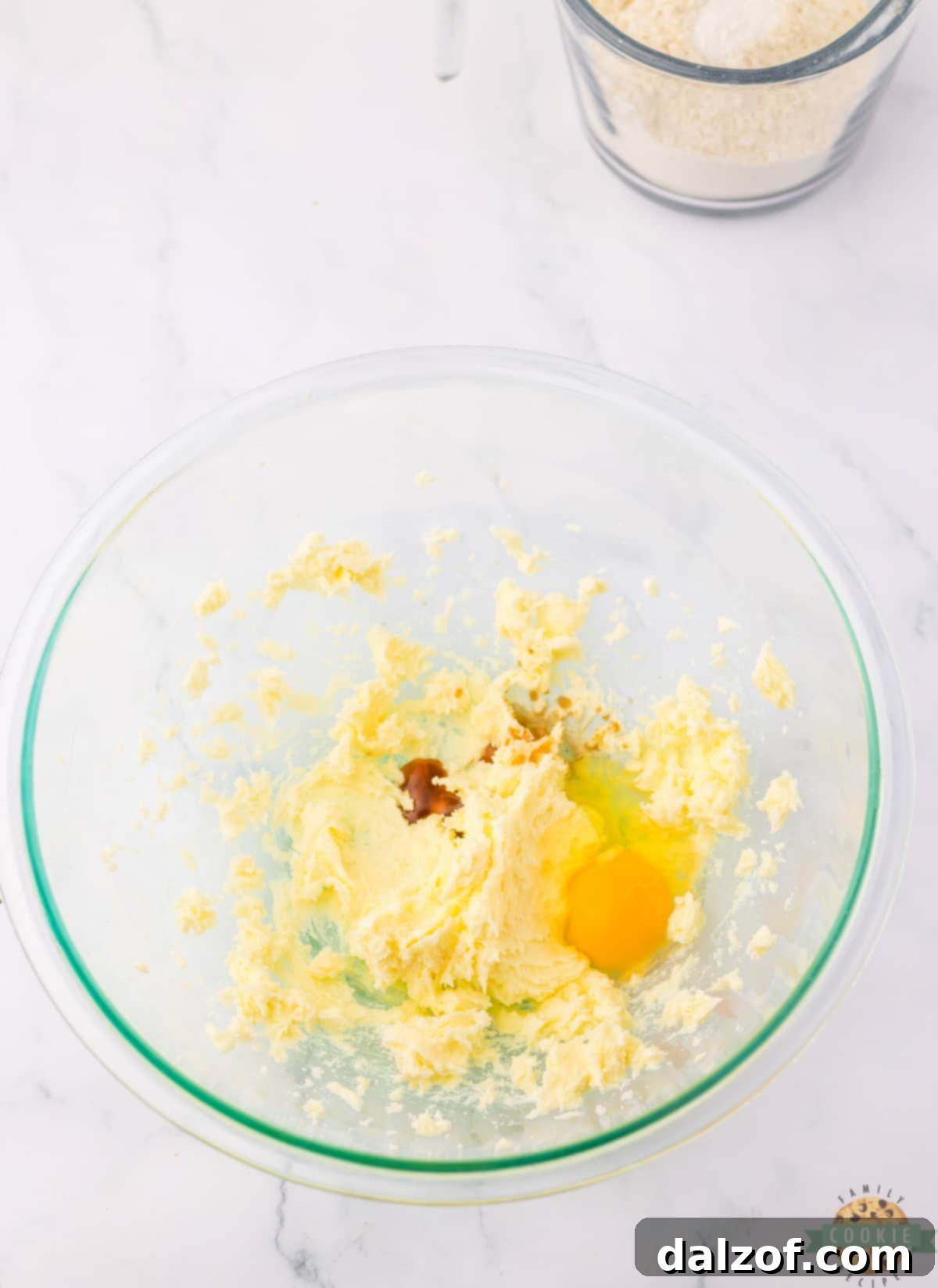 Mixing butter, sugar, egg and vanilla together. 