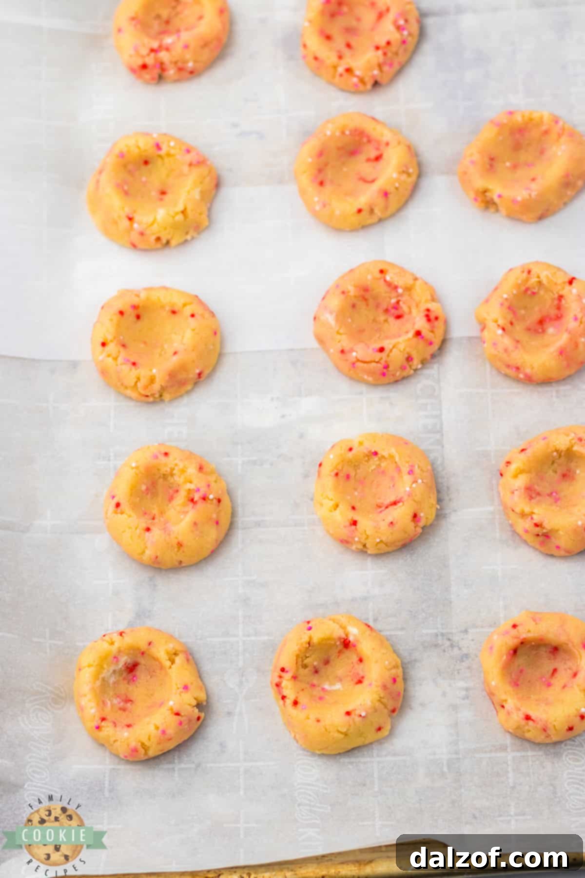 Shaping thumbprint cookies before baking.