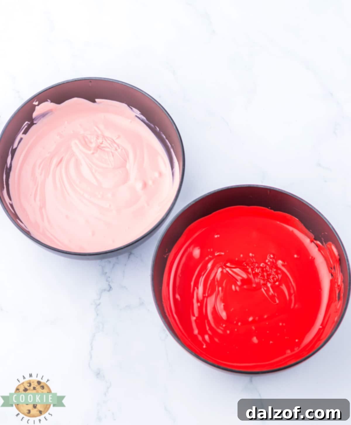 Melting red and pink chocolate to make chocolate filling. 