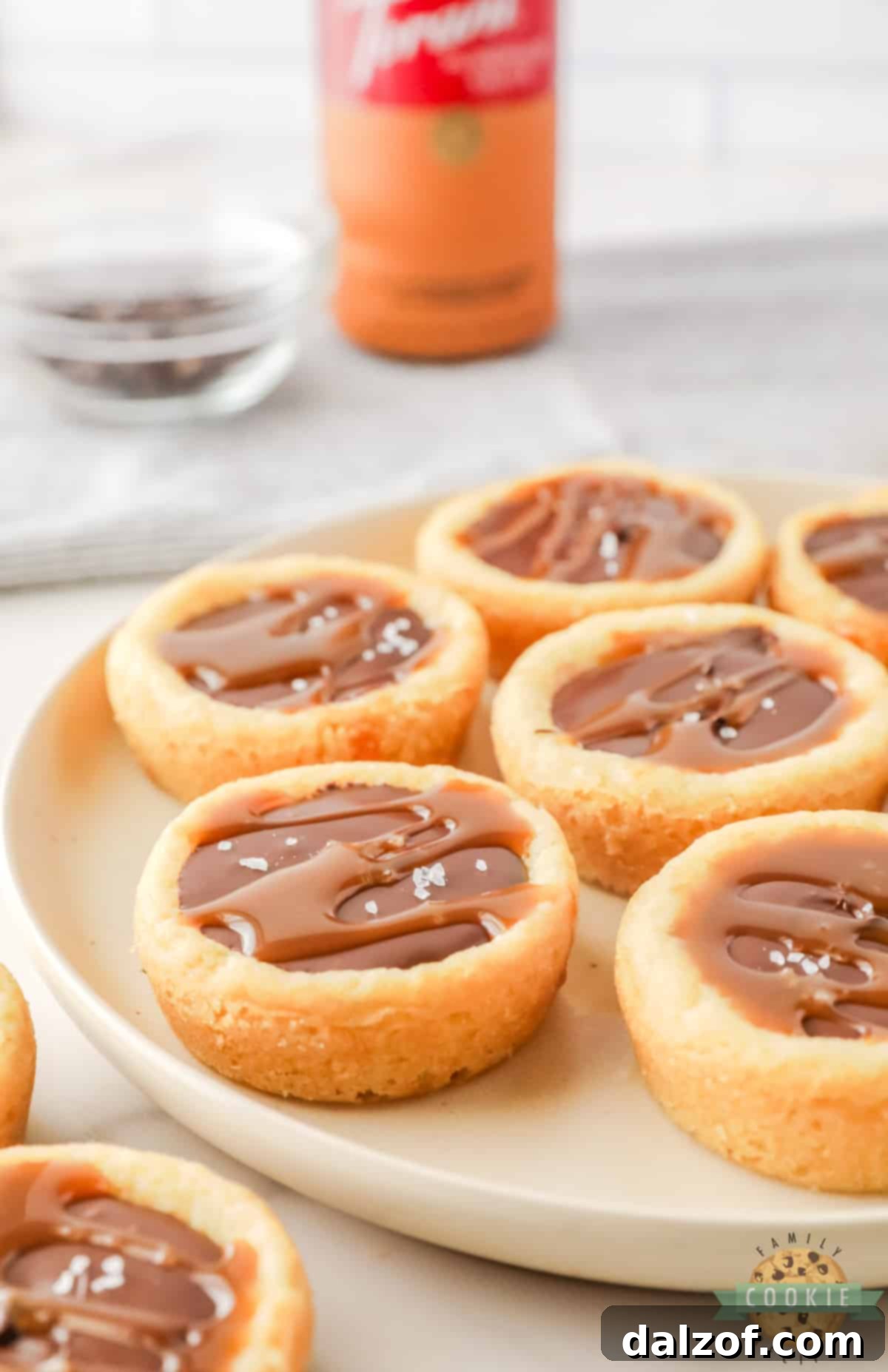 Sugar cookie cup filled with caramel and chocolate.
