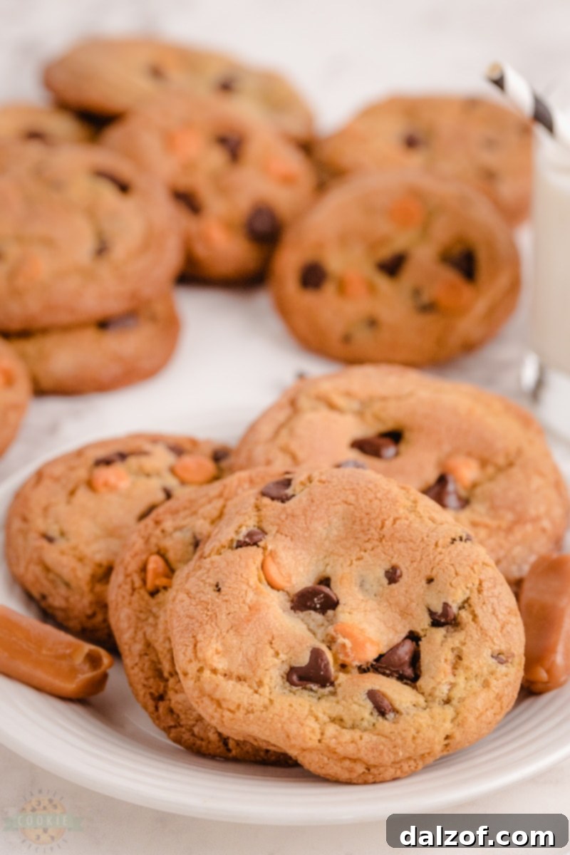 Close-up of a freshly baked Caramel Chocolate Chip Cookie with gooey caramel oozing out