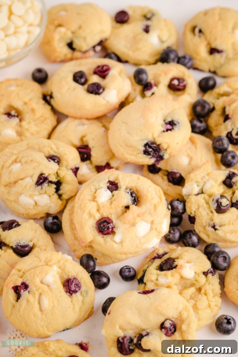 Close-up of a stack of soft Blueberry Cream Cookies with visible blueberries