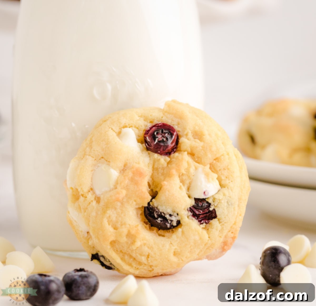 A plate of Blueberry Cream Cookies with a glass of milk