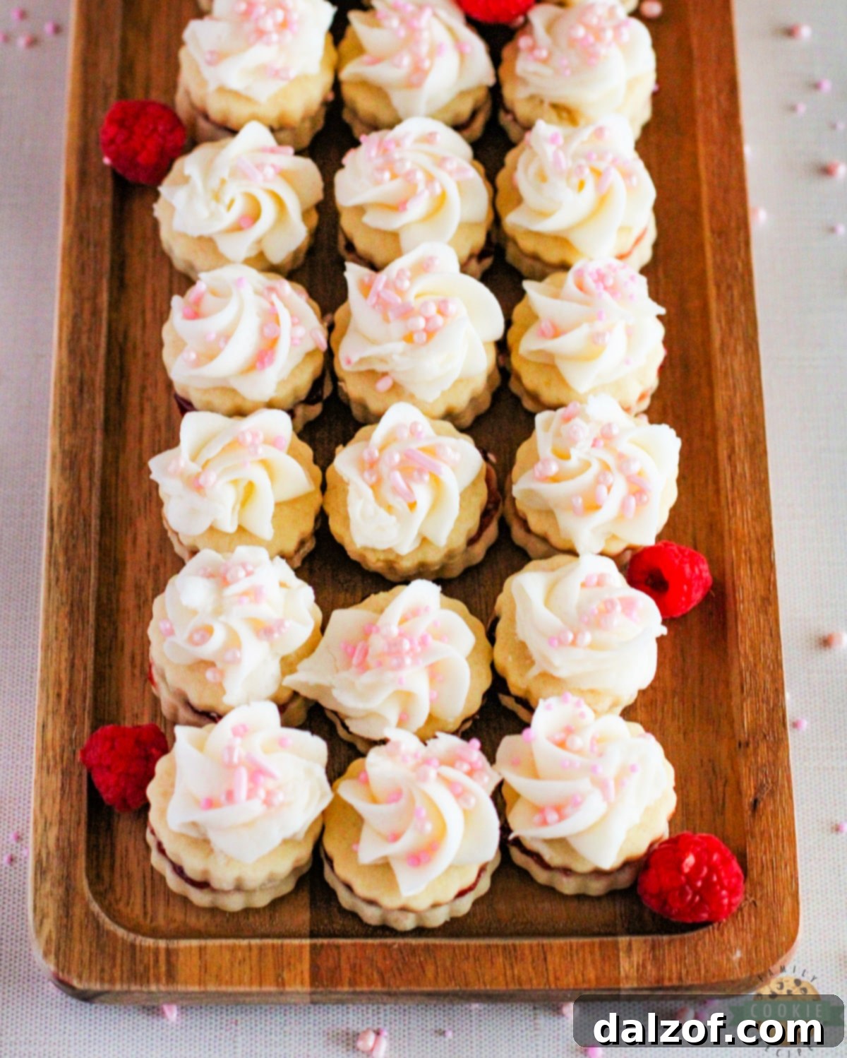 Empire Cookies are buttery shortbread cookie sandwiches filled with raspberry jam and topped with a simple buttercream frosting. Delicious cookies that are both pretty and delicious!