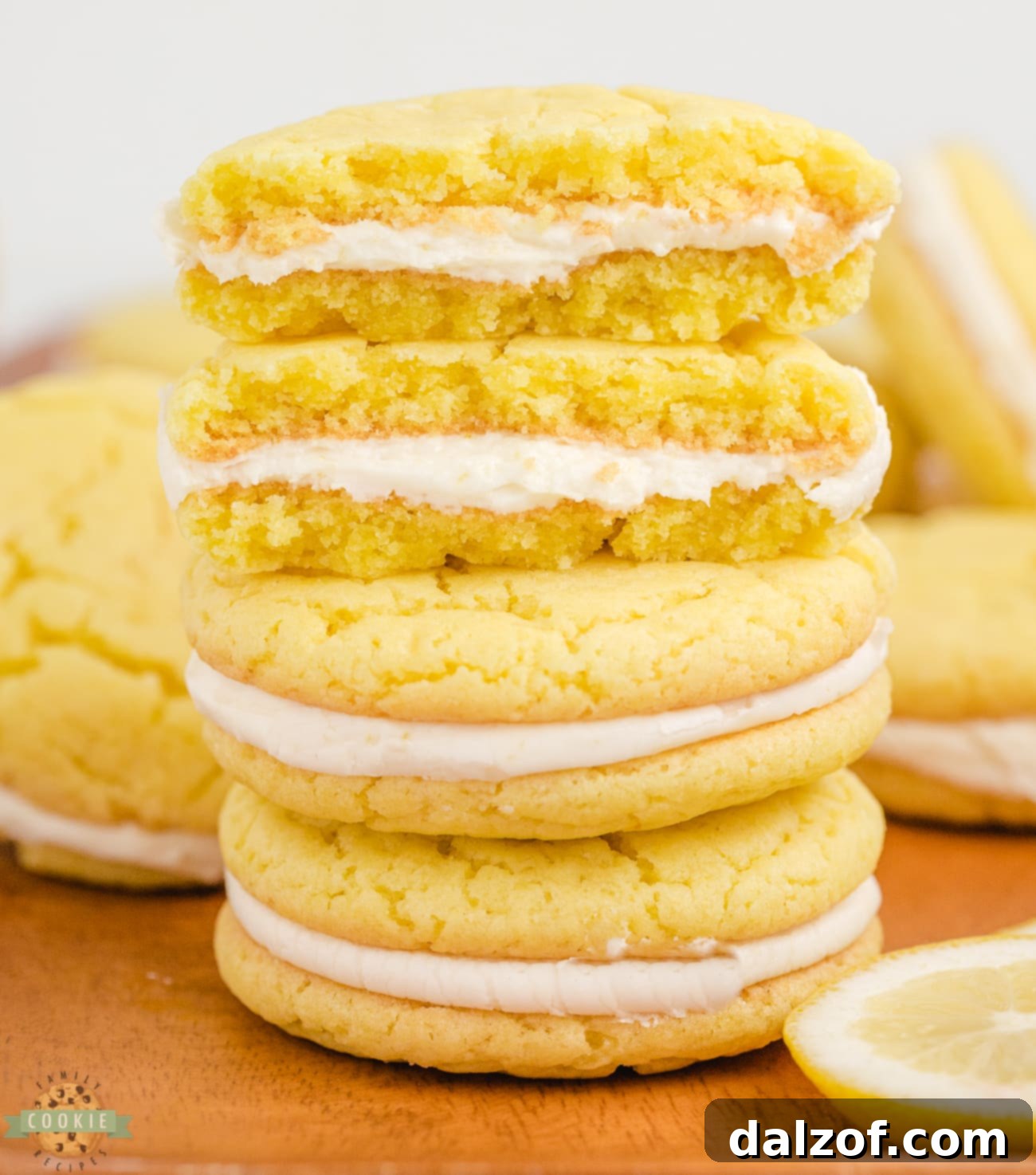 Zesty Lemon Oreo Cake Mix Cookies 3 Close-up of a lemon cake mix oreo cookie cut in half, revealing the soft lemon cookie and creamy lemon filling.