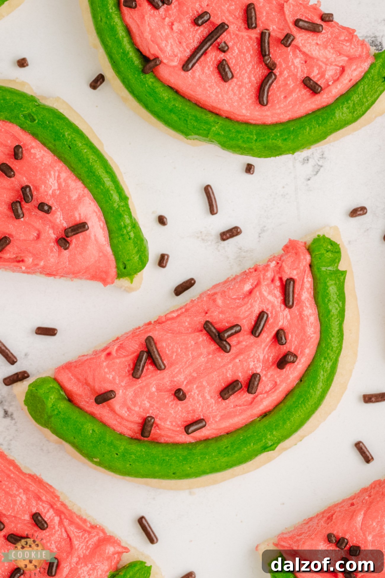 A delightful display of darling pink and green frosted watermelon cookies arranged appealingly.