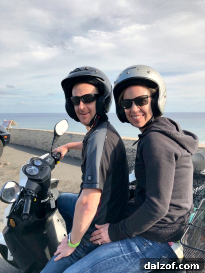 A couple enjoying a scooter ride in Hawaii.