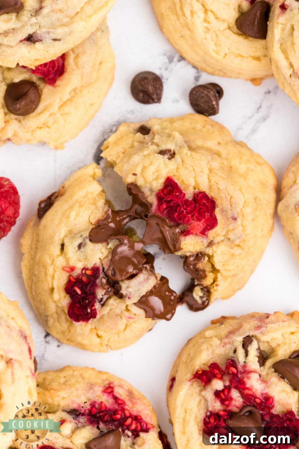 A plate of delicious chocolate chip cookies with fresh raspberries, highlighting their perfect texture.