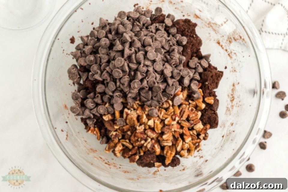 Chocolate cake mix cookie dough ready for baking, showcasing the thick texture with visible chocolate chips and pecans.