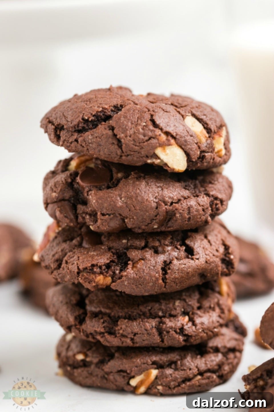 A stack of perfectly baked chocolate cake mix cookies with visible chocolate chips and pecans, ready to be enjoyed.