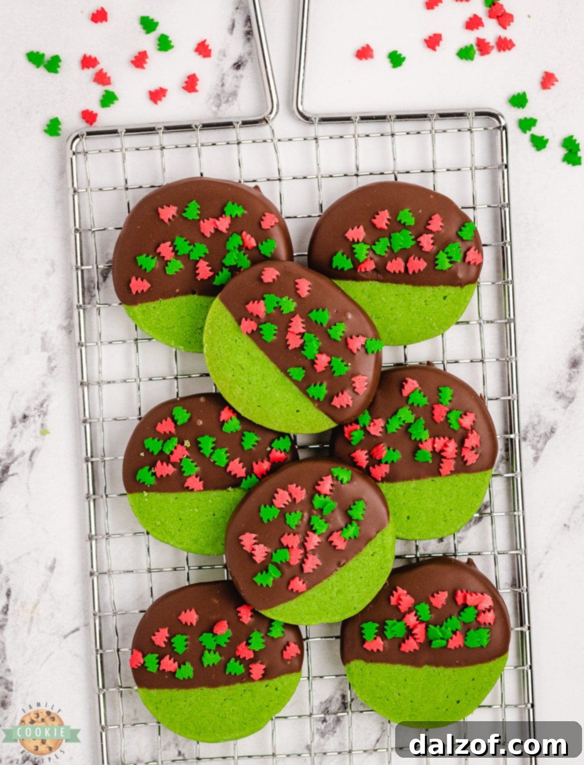 Freshly baked chocolate-dipped Christmas cookies resting on a cooling rack, the chocolate coating setting beautifully.