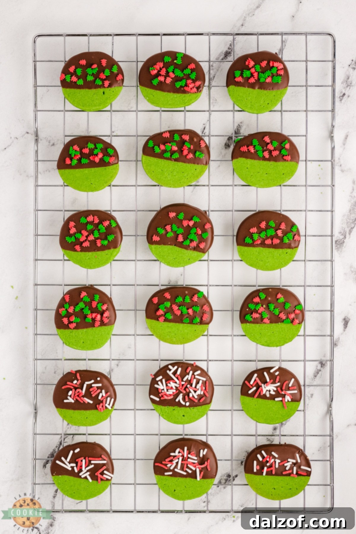 Green mint Christmas cookies cooling on a wire rack, ready for their delicious chocolate dip.