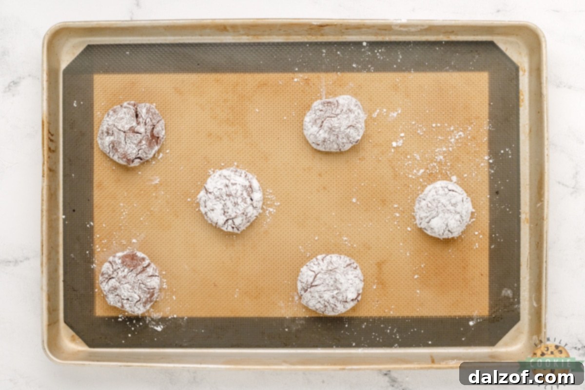 Roll cookie dough balls in powdered sugar. 