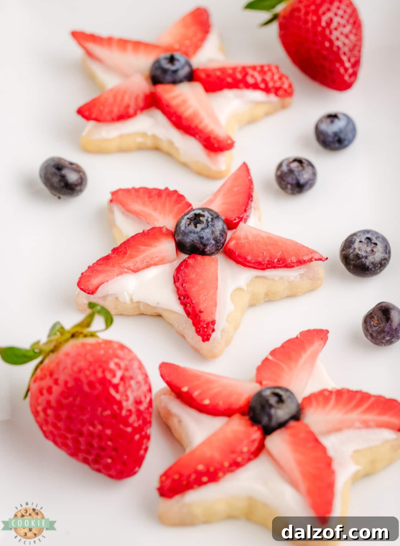 Platter of berry star cookies with strawberries and blueberries