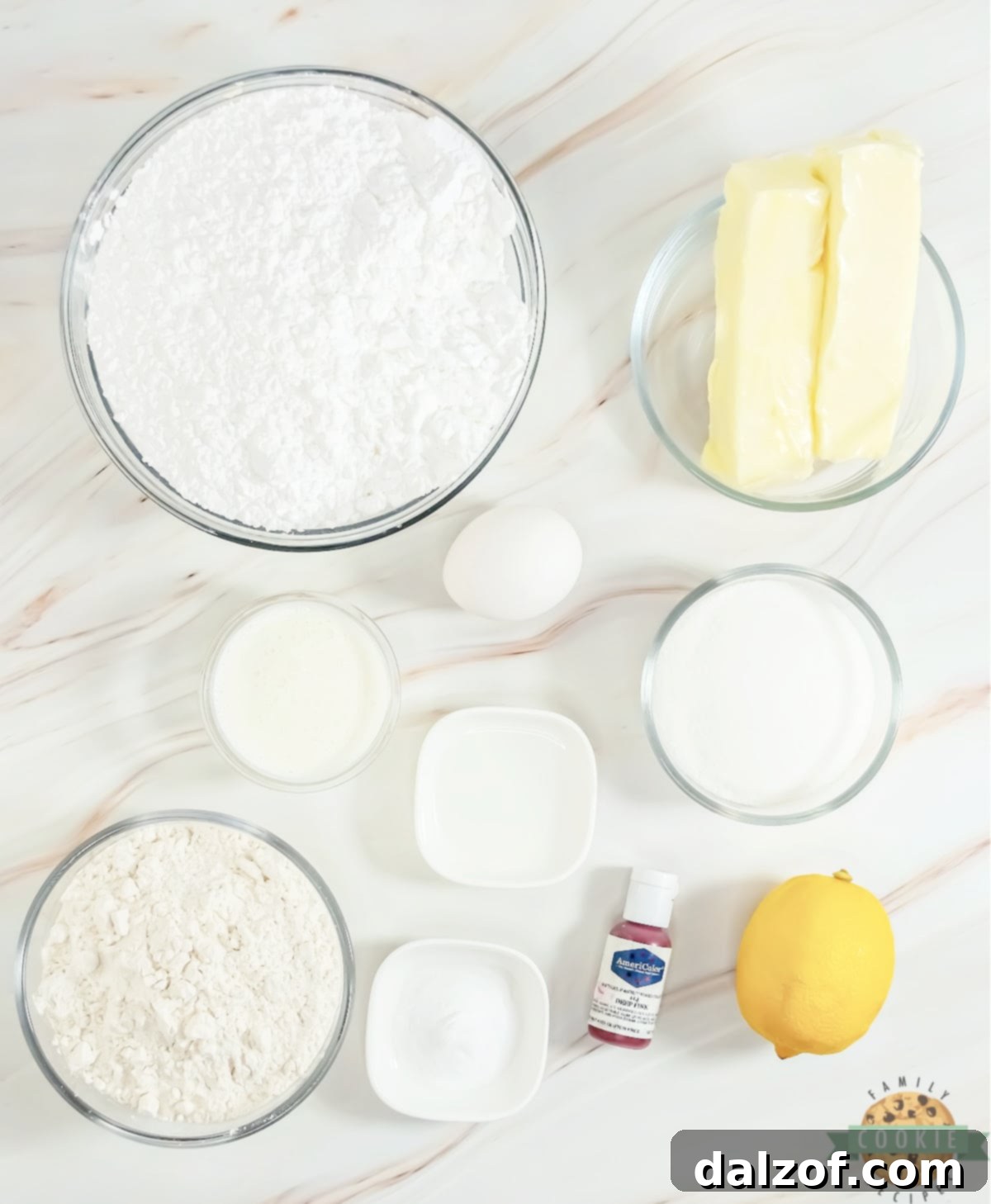 Fresh ingredients laid out for making delicious pink lemonade cookies, including butter, sugar, lemon extract, and flour.