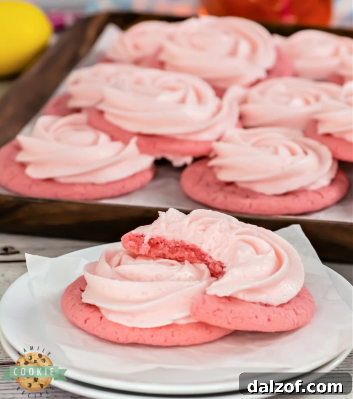 Perfectly baked pink lemonade cookies, showing their soft texture and subtle pink hue, ready for frosting.