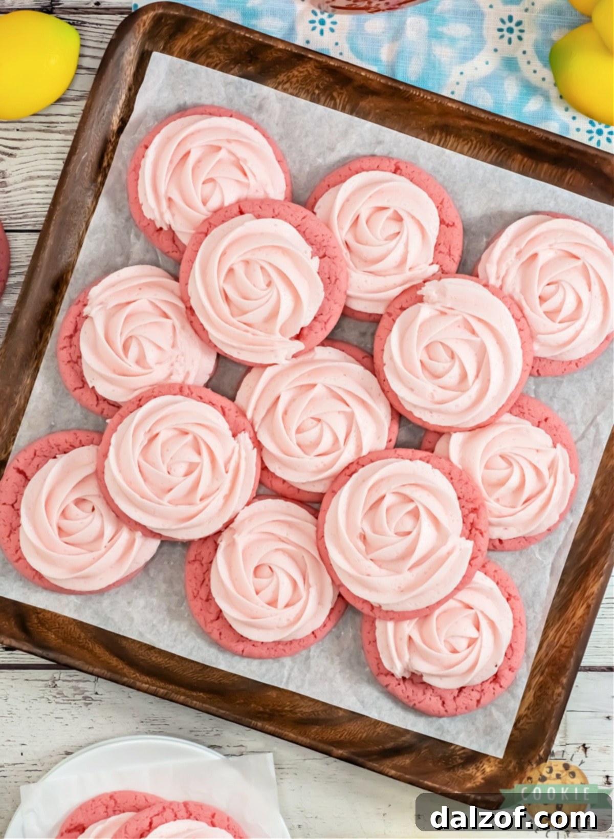 Close-up of a beautifully frosted pink lemonade cookie, showcasing its soft texture and inviting appearance.