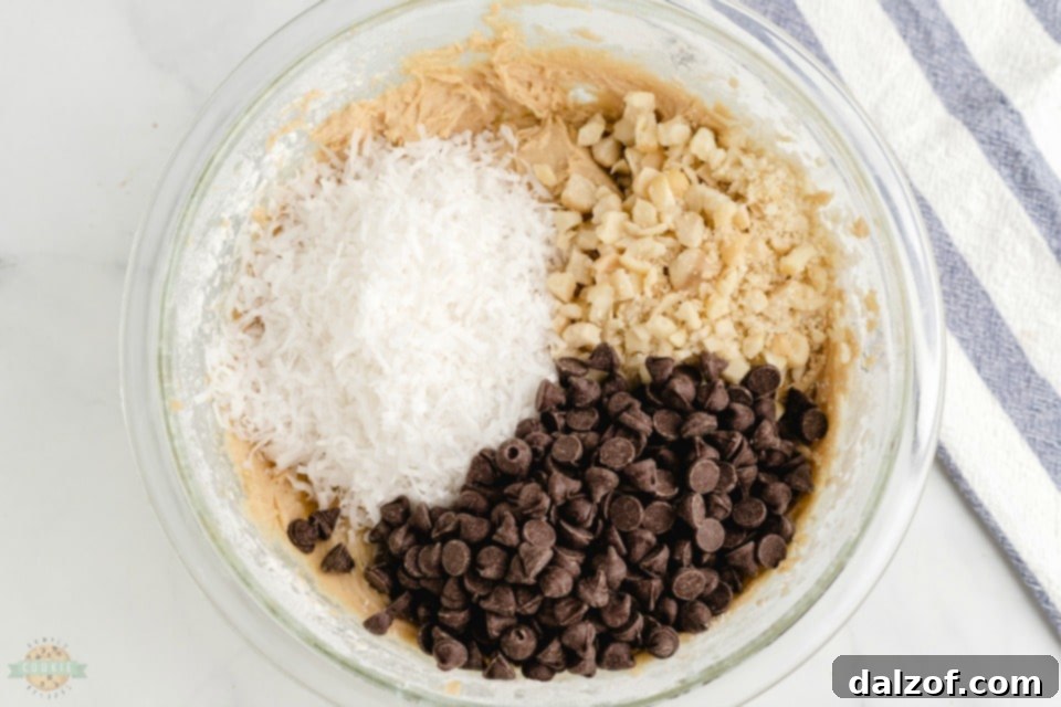 How to make Chocolate chip macadamia nut cookies - showing prepared dough with chocolate chips, coconut, and macadamia nuts