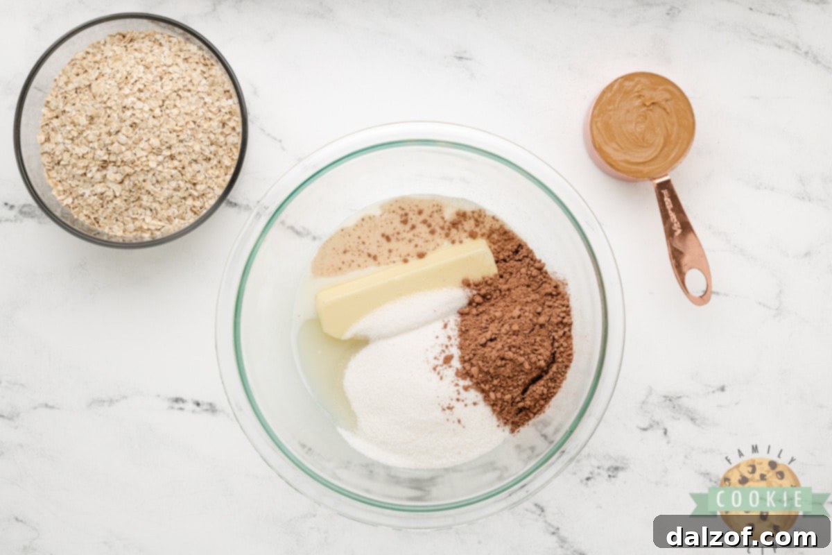 The initial step of making Microwave No-Bake Cookies: butter, milk, cocoa powder, and sugar are combined in a bowl, ready for microwaving.