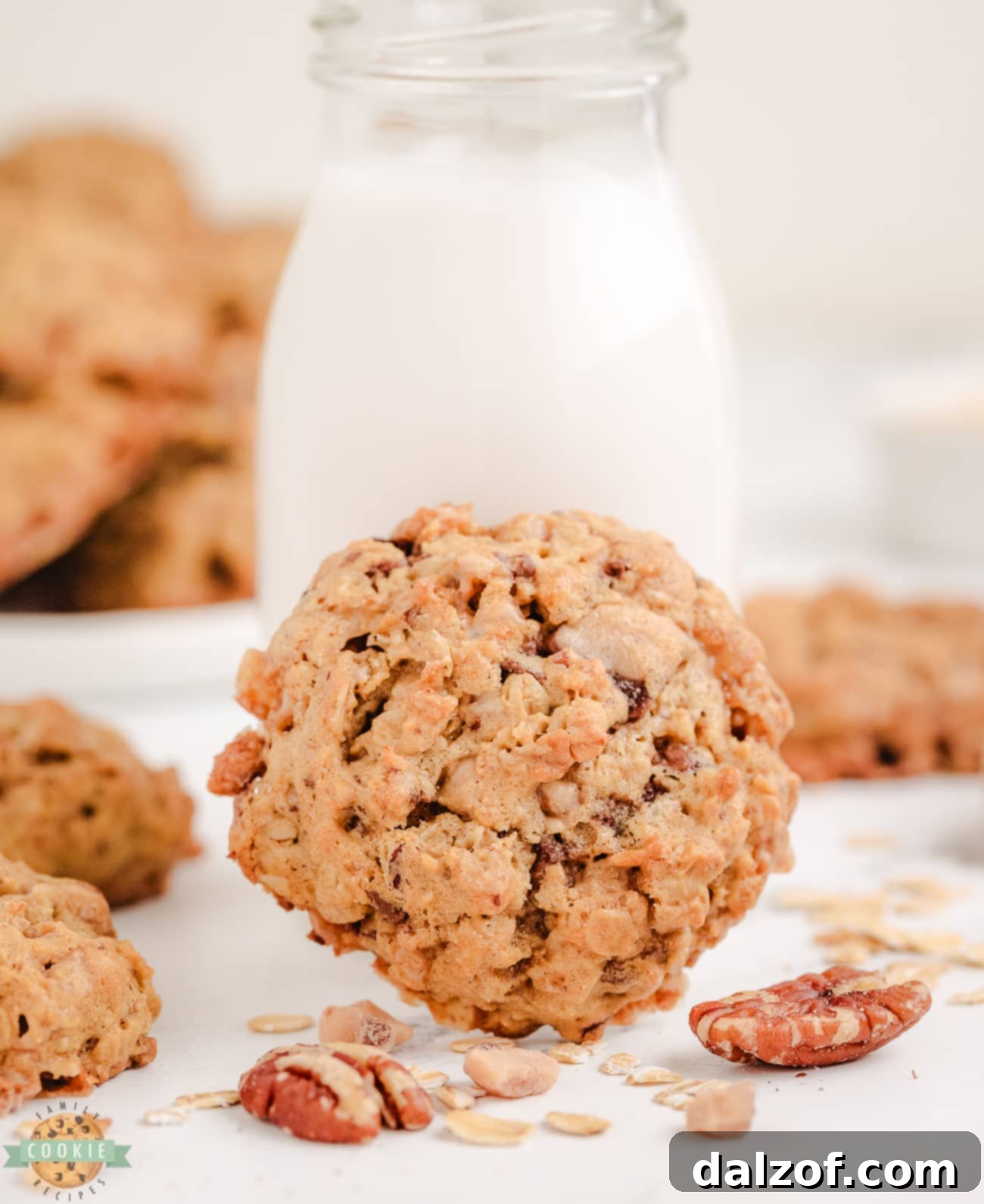 A perfectly baked oatmeal toffee pecan cookie placed next to a refreshing glass of milk, inviting a delicious snack
