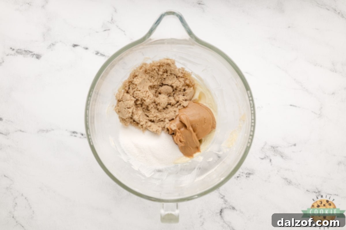 Ultimate Reese Peanut Butter Pudding Cookies 8 Add sugars and peanut butter to creamed butter. Granulated sugar, brown sugar, and creamy peanut butter added to the bowl with creamed butter, ready for mixing.