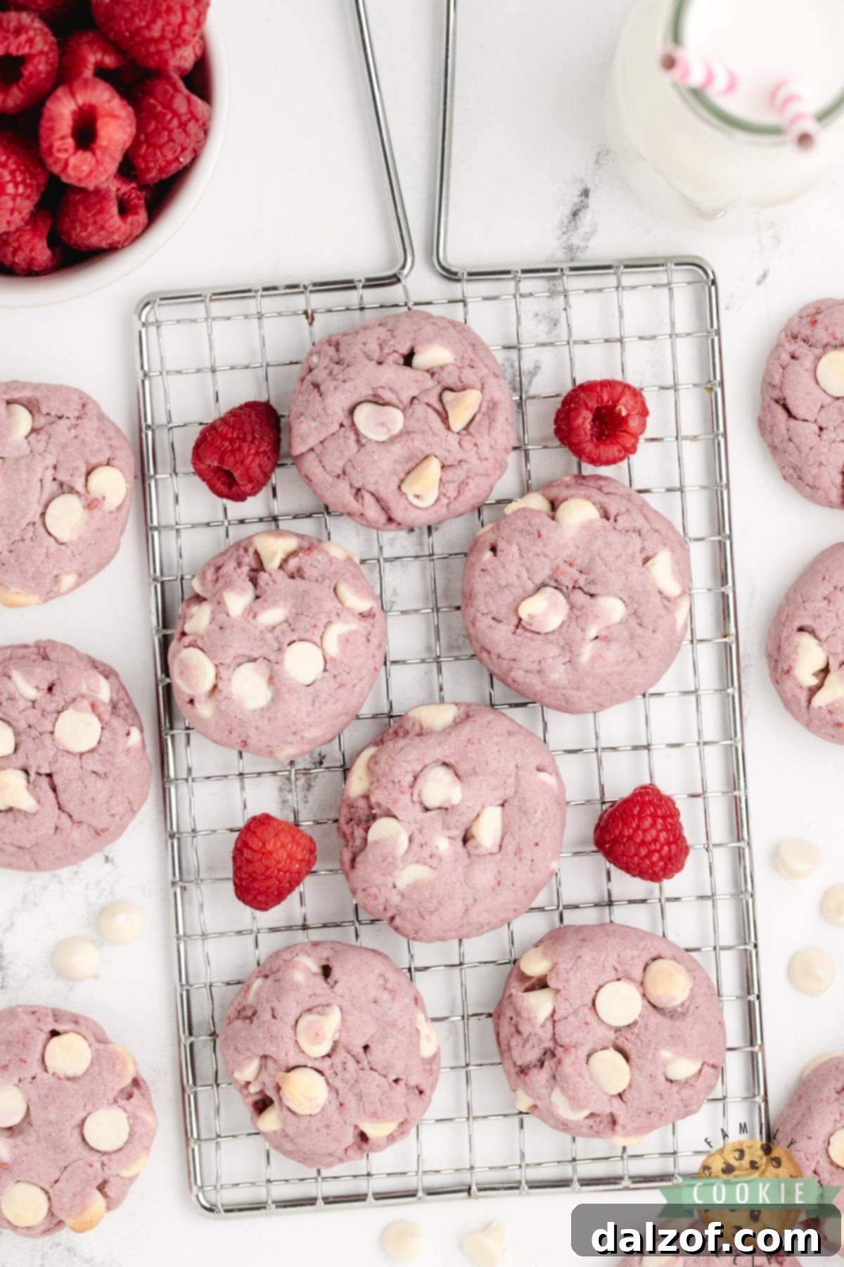 A batch of baked Raspberry and White Chocolate Chip Cookies cooling on a rack, highlighting their inviting appearance.